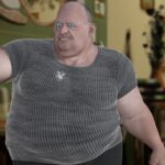 Obese white man with cocaine powder on his gray shirt.