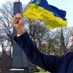 Joe Biden holding a Ukraine flag inside of a cemetery on Memorial Day.