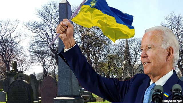 Joe Biden holding a Ukraine flag inside of a cemetery on Memorial Day.