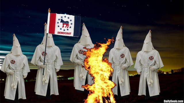 Democrats wearing KKK robes burning fire in dark field.