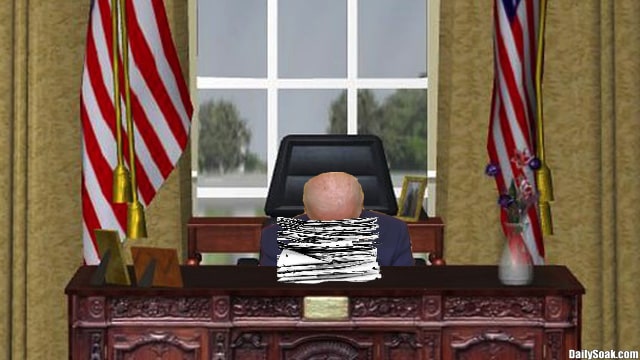 Joe Biden with his head down on Resolute Desk inside Oval Office at White House.