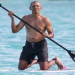 Barack Obama paddle boarding at Martha's Vineyard with Devon Archer.
