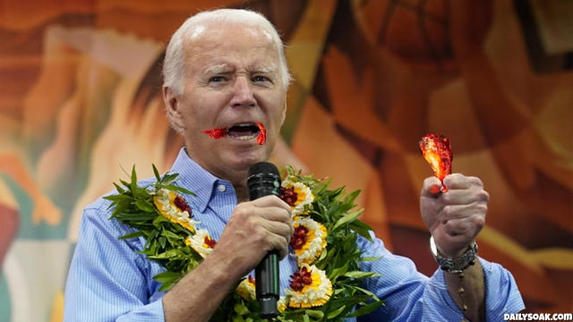 Joe Biden eating a fiery buffalo chicken wing during Maui Hawaii speech.