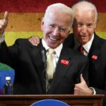 Joe Biden hugging a lookalike Joe Biden Robert L. Peters behind a podium.
