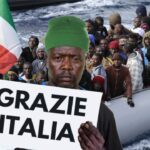 Black African migrants in Italy coming ashore by boat.