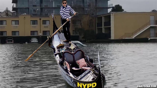 NYPD police officer riding a boat through flooded New York City.