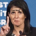 Nikki Haley with tattoo on her forehead giving speech.