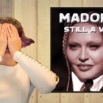 Woman covering her eyes in front of Madonna music album cover.