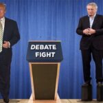 Donald Trump and Robert De Niro on stage in front of a blue curtain.