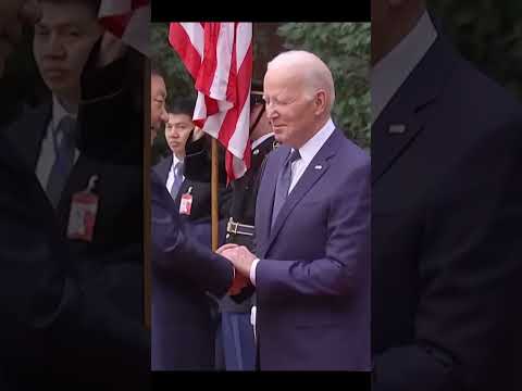 Joe Biden shaking hands with Xi Jinping.