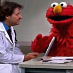 Sesame Street's Elmo talking to a doctor inside a physician's office.