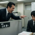 Japanese boss in business suit yelling at his Japanese male employee.