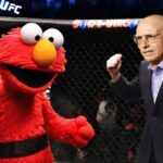 Larry David and Elmo fighting inside the UFC MMA octagon ring.