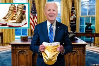 Joe Biden holding up a golden diaper nest to Donald Trump's sneakers.