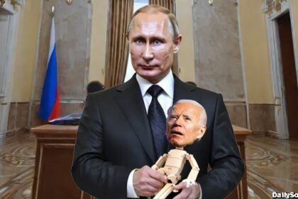 Russian President Vladimir Putin holding a joe Biden puppet.