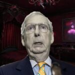 Mitch McConnell standing inside of a dark, red vampire's room.