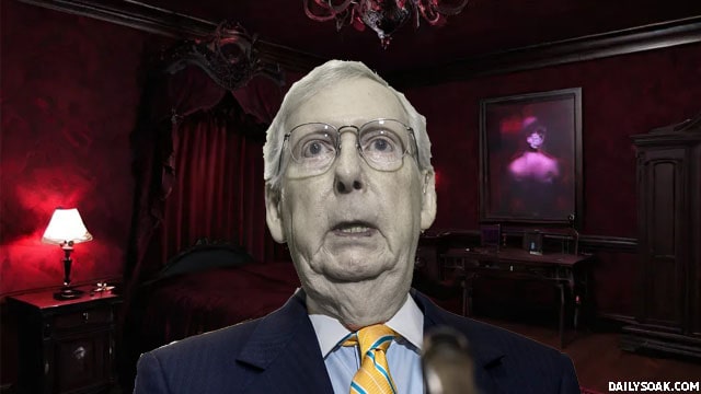 Mitch McConnell standing inside of a dark, red vampire's room.