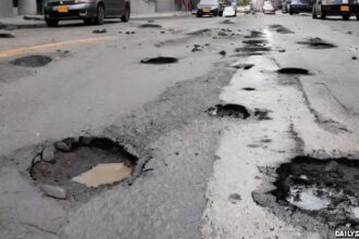 Potholes on street in New York City road.