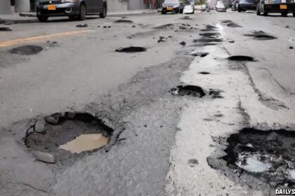 Potholes on street in New York City road.