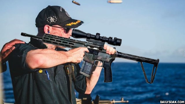 US Navy soldier with his gun scope and gun backwards.