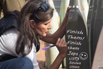 Nikki Haley writing 'Finish Them' on a bomb in Israel.