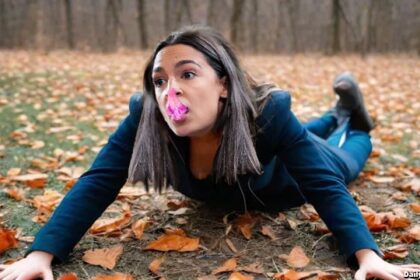 AOC on ground with chewing gum all over her face.