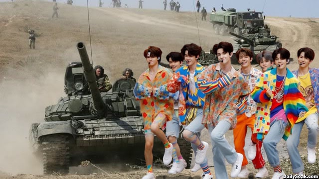 South Korean K-Pop boy band dancing in colorful outfits in front of Russian soldiers in Ukraine.