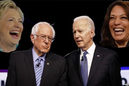 Joe Biden and Bernie Sanders on stage during a debate.