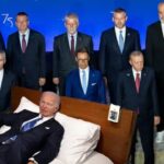 Joe Biden sleeping on a bed on stage at NATO Summit.