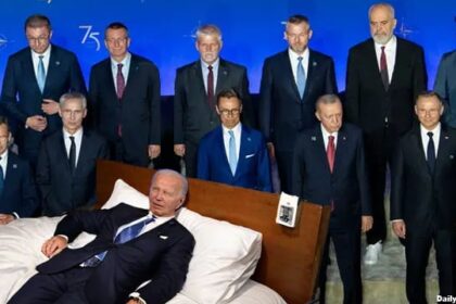 Joe Biden sleeping on a bed on stage at NATO Summit.