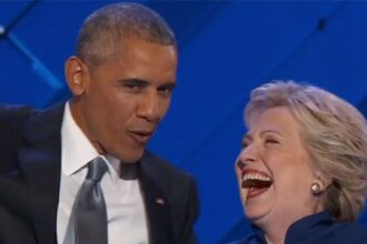 Democrat party members Hillary Clinton and Barack Obama laughing.