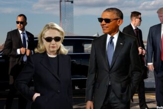 Donald Trump surrounded by Secret Service agents and Hillary Clinton and Barack Obama wearing black suits.