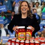 Kamala Harris at Atlanta rally with jars of hot sauce.