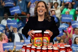 Kamala Harris at Atlanta rally with jars of hot sauce.