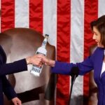 Nancy Pelosi and Kamala Harris holding a bottle of alcohol.