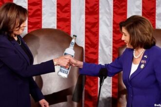 Nancy Pelosi and Kamala Harris holding a bottle of alcohol.