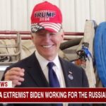 Joe Biden wearing a Trump MAGA hat.