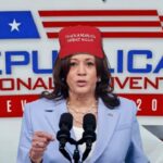 Kamala Harris wearing a Donald Trump MAGA hat.