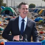 Gavin Newsom signing a bill banning AI generated images and election deepfakes.