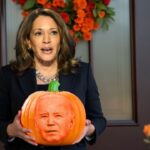 Kamala Harris holding a pumpkin on Halloween.