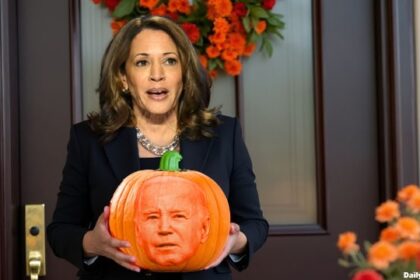 Kamala Harris holding a pumpkin on Halloween.