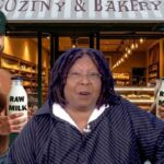 Two muscular RFK Jr. supporters holding raw milk in front of Whoopi Goldberg.