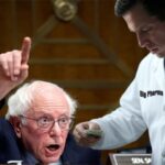 Big Pharma executive shoving money into Bernie Sanders' pocket.