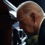 Joe Biden sniffing the casket of Jimmy Carter.