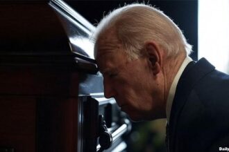 Joe Biden sniffing the casket of Jimmy Carter.