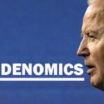 Joe Biden in front of a Bidenomics sign.