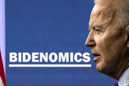 Joe Biden in front of a Bidenomics sign.