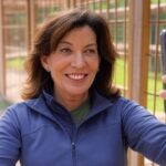 New Governor Kathy Hochul taking a selfie in front of a bear cage.