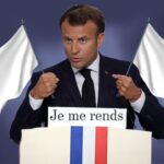 France President Emmanuel Macron holding up two white flags of surrender.