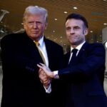 Donald Trump and Emmanuel Macron shaking hands at airport.